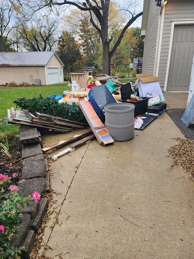 Dumpster being loaded with debris for Roofing Dumpster Rental in Westport